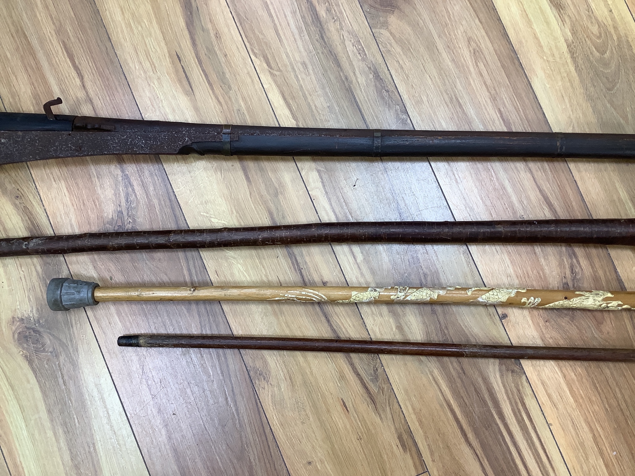 An Indian matchlock rifle and 3 walking sticks